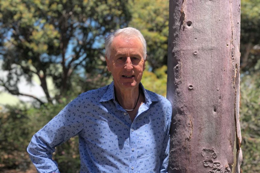 Professor Ross Dowling standing next to a tree at Edith Cowan University. 