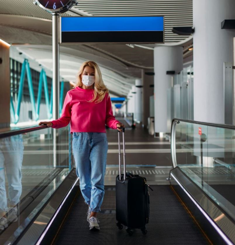 women walking through airport with mask 